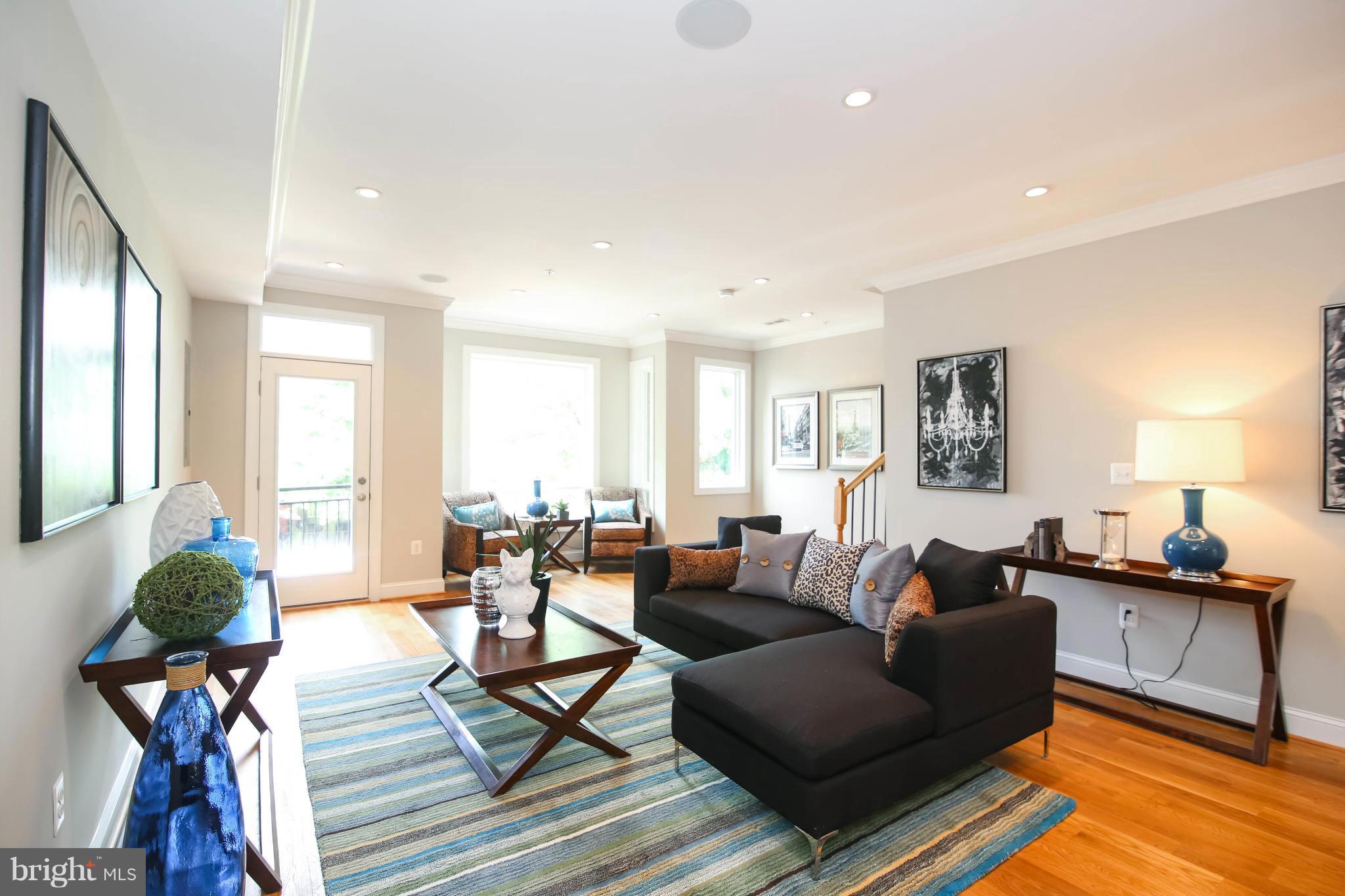1131 5th Street Northeast, Unit 2 Washington, DC 20002 - Photo 3 of 27 a living room with furniture and a large window