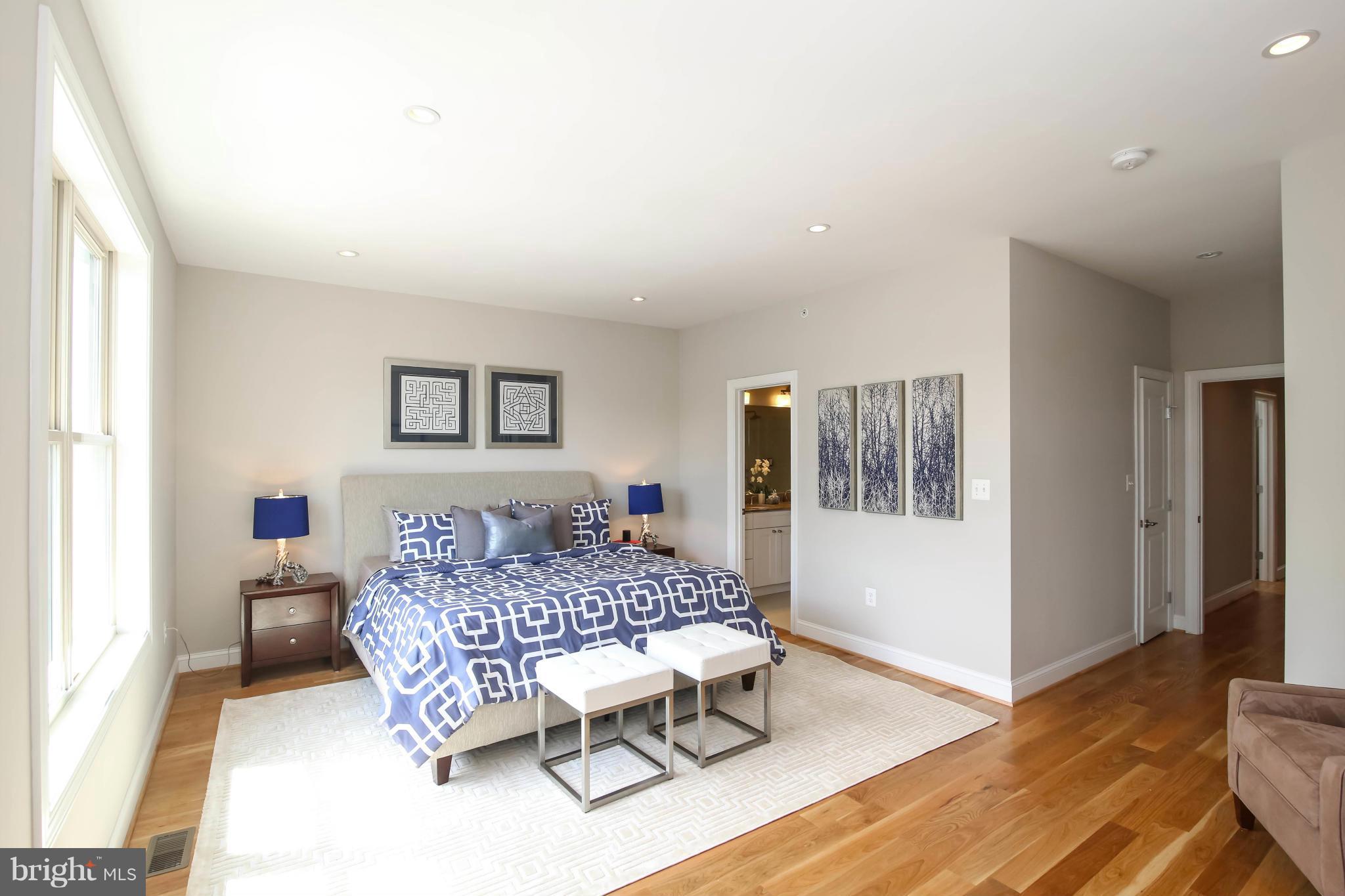 1131 5th Street Northeast, Unit 2 Washington, DC 20002 - Photo 21 of 27 a bedroom with a bed and wooden floor