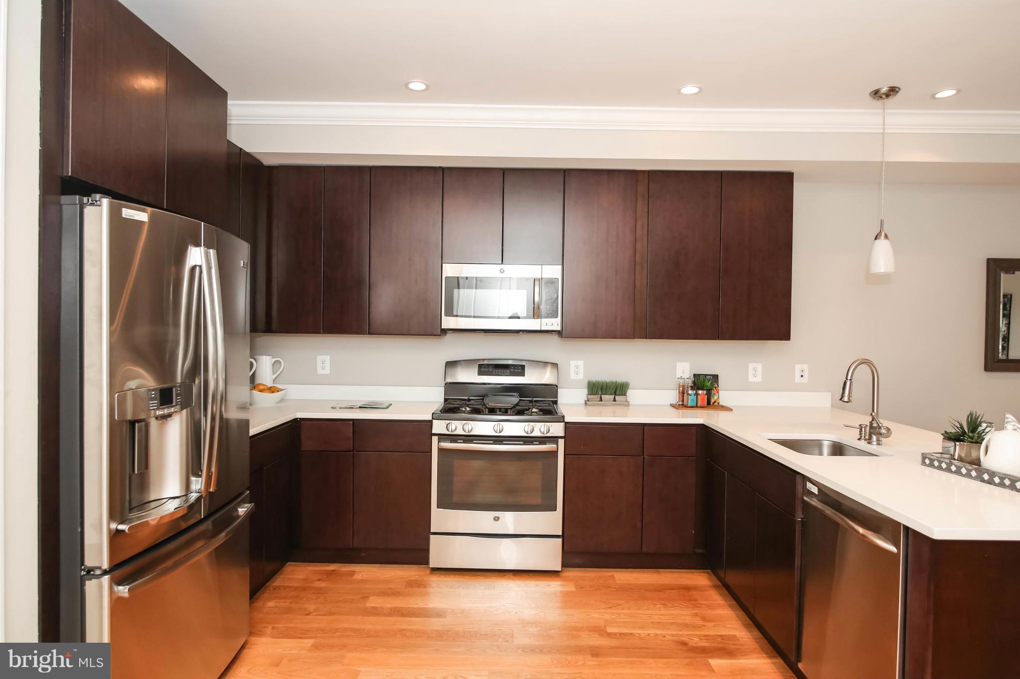 1131 5th Street Northeast, Unit 2 Washington, DC 20002 - Photo 8 of 27 a kitchen with a sink appliances and cabinets