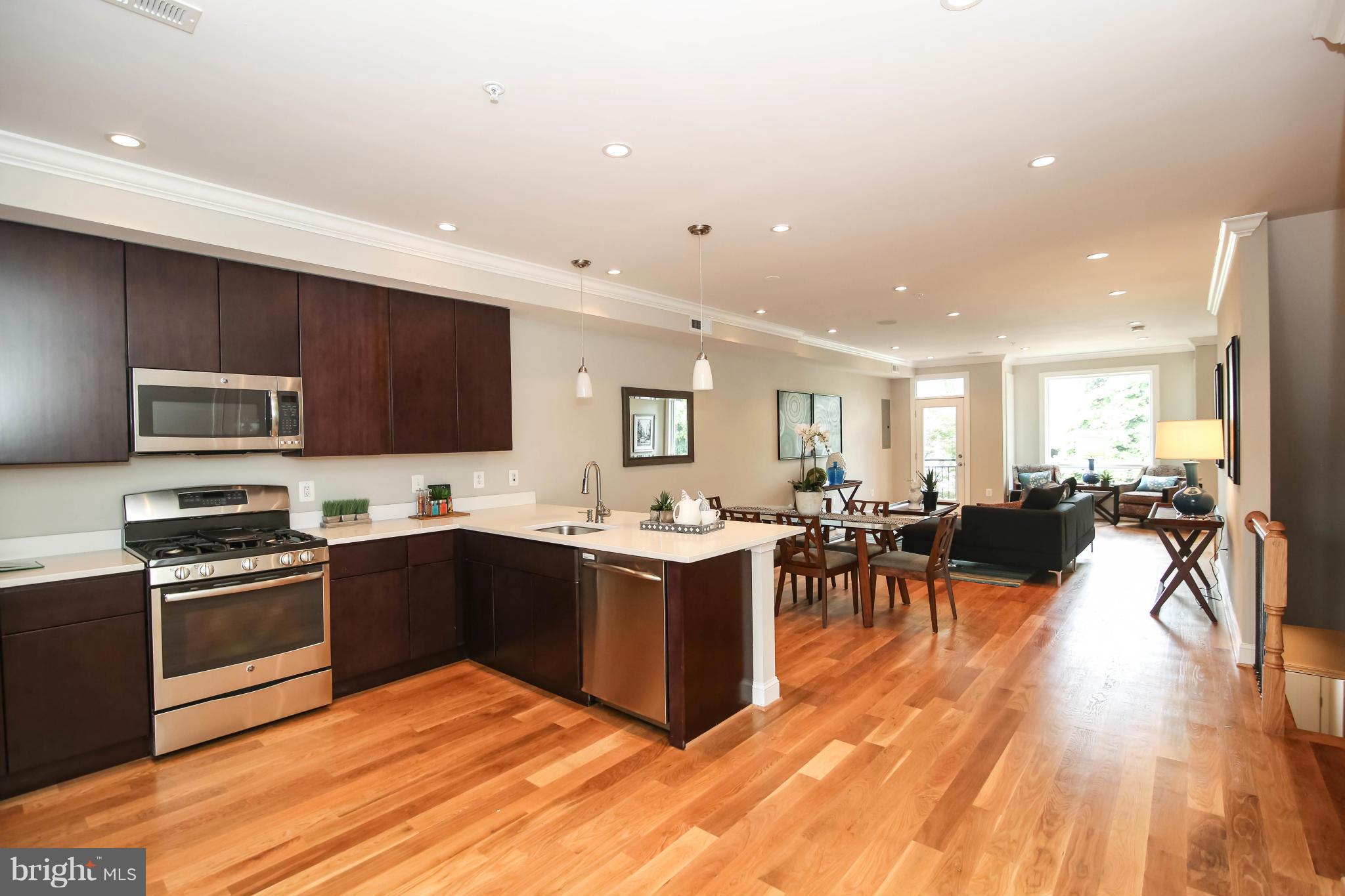 1131 5th Street Northeast, Unit 2 Washington, DC 20002 - Photo 9 of 27 a view of kitchen with sink stove and cabinets