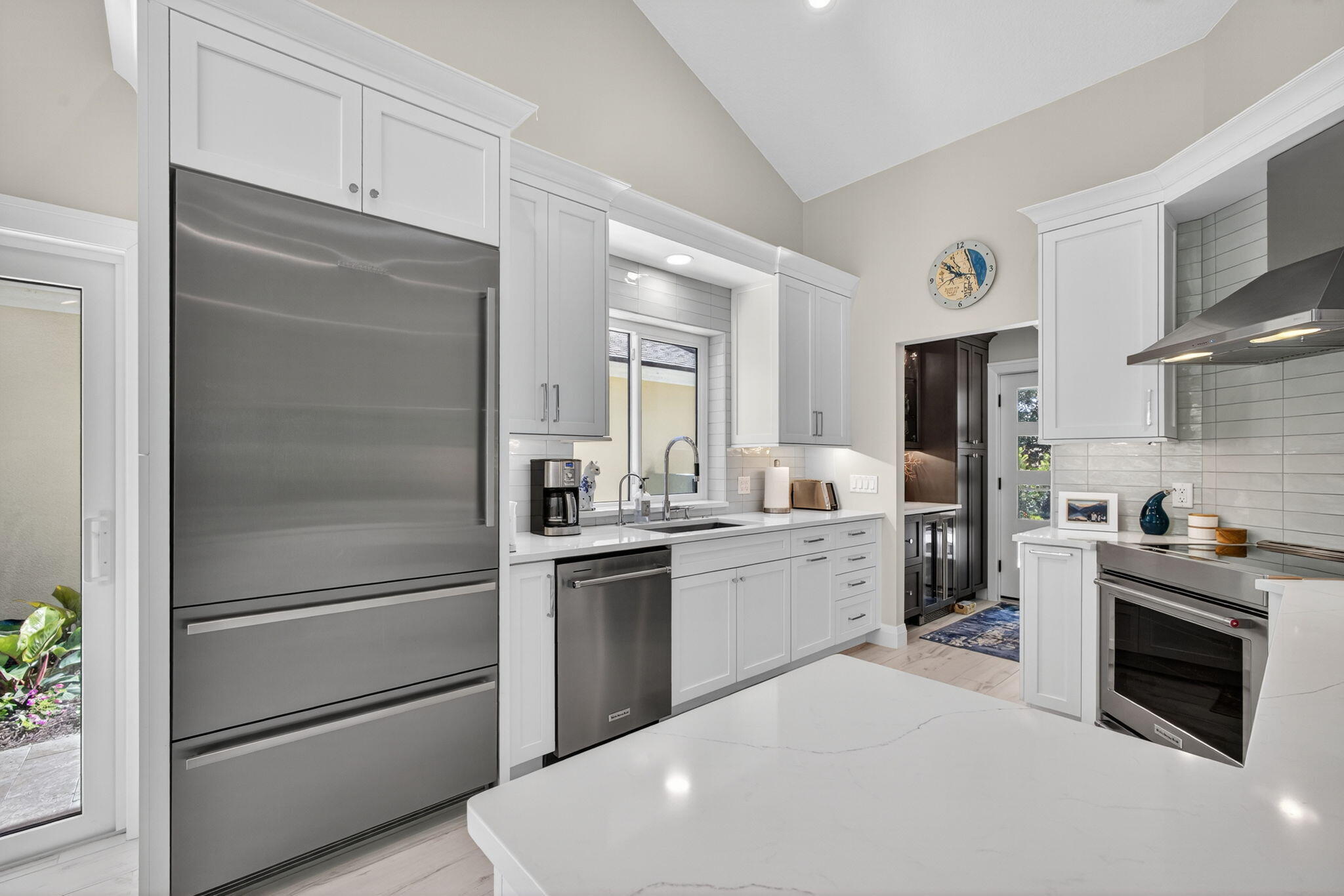 156 Ocean Pines Terrace Jupiter, FL 33477 - Photo 11 of 41 a kitchen with a refrigerator stove and sink
