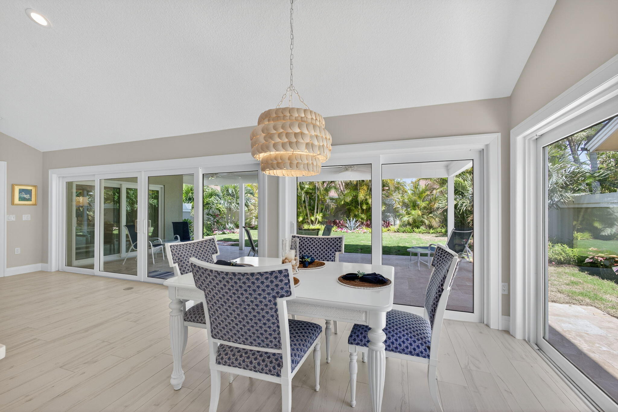 156 Ocean Pines Terrace Jupiter, FL 33477 - Photo 14 of 41 a view of a dining room with furniture large windows and wooden floor