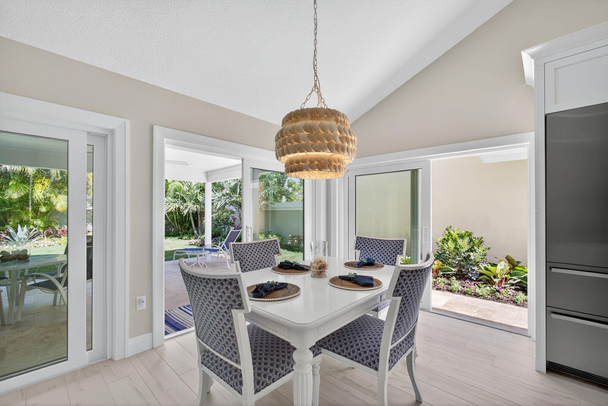 156 Ocean Pines Terrace Jupiter, FL 33477 - Photo 15 of 41 a dining room with furniture potted plants and wooden floor