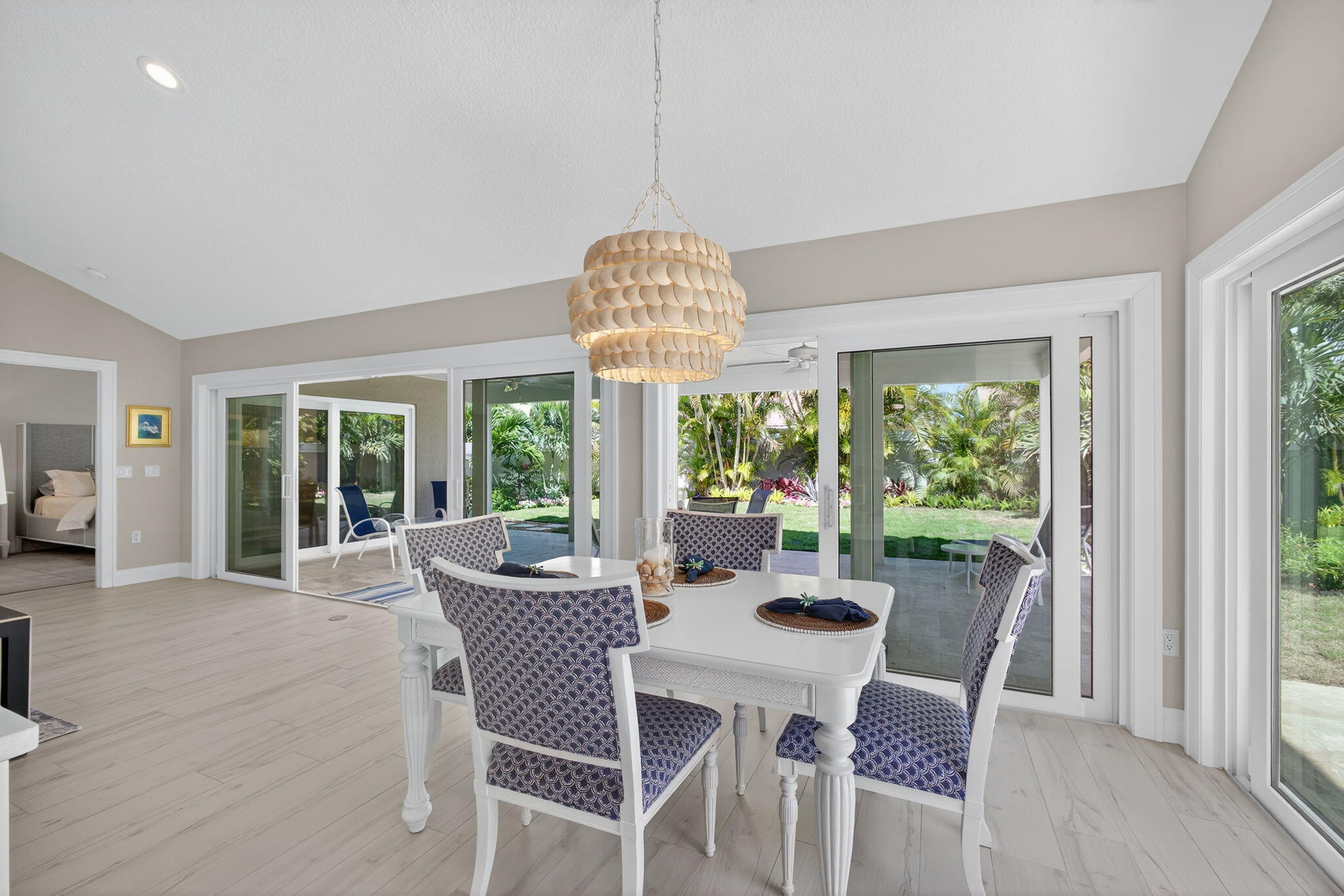 156 Ocean Pines Terrace Jupiter, FL 33477 - Photo 17 of 41 a dining room with furniture a chandelier and wooden floor