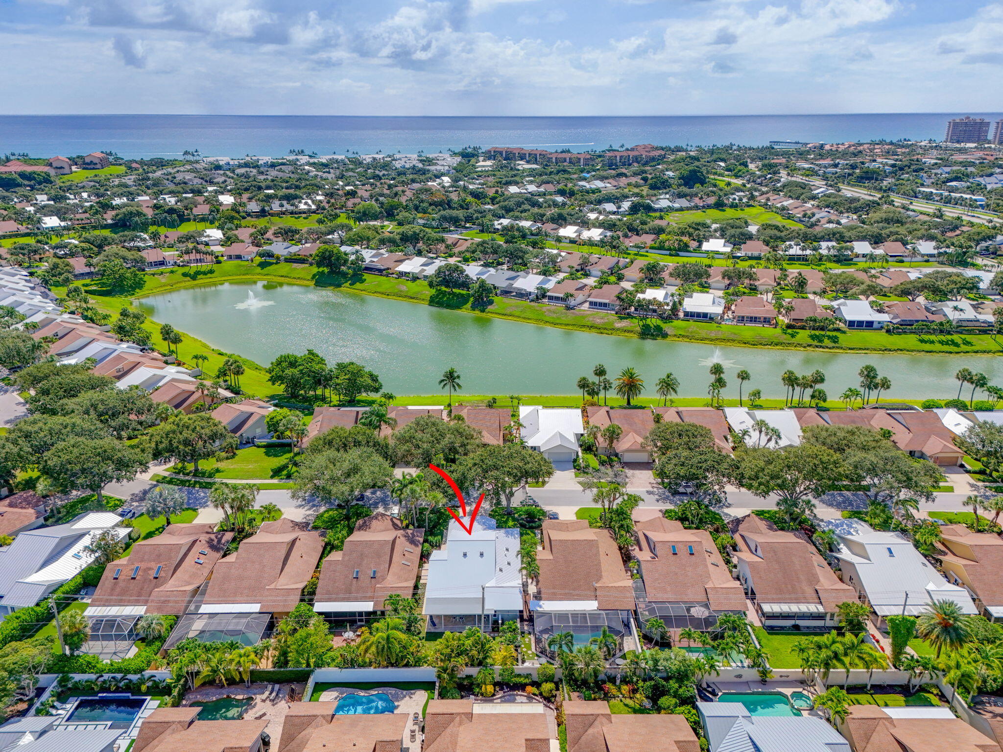 156 Ocean Pines Terrace Jupiter, FL 33477 - Photo 38 of 41 an aerial view of a city with lots of residential buildings lake and ocean view