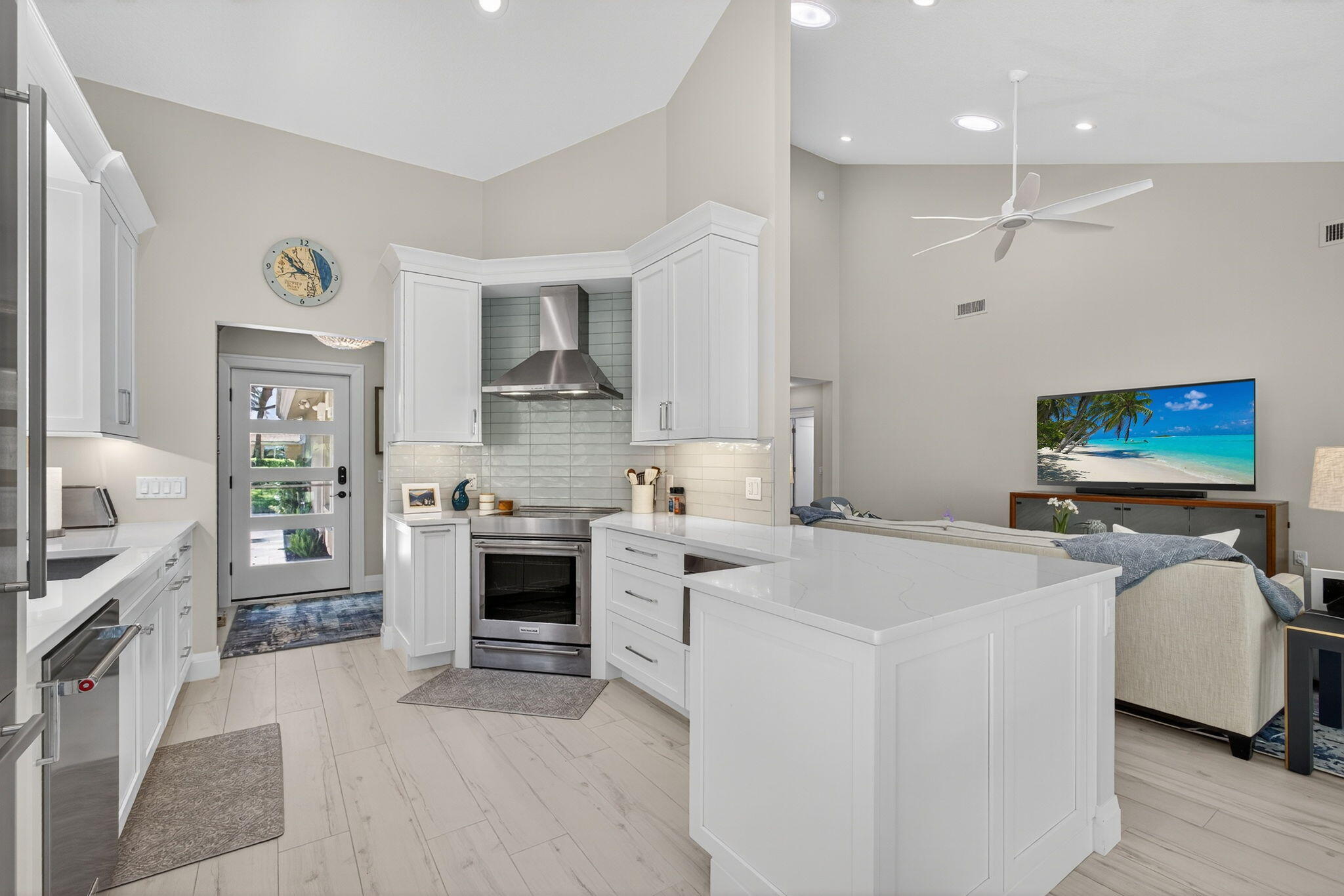 156 Ocean Pines Terrace Jupiter, FL 33477 - Photo 9 of 41 a large white kitchen with cabinets and wooden floor