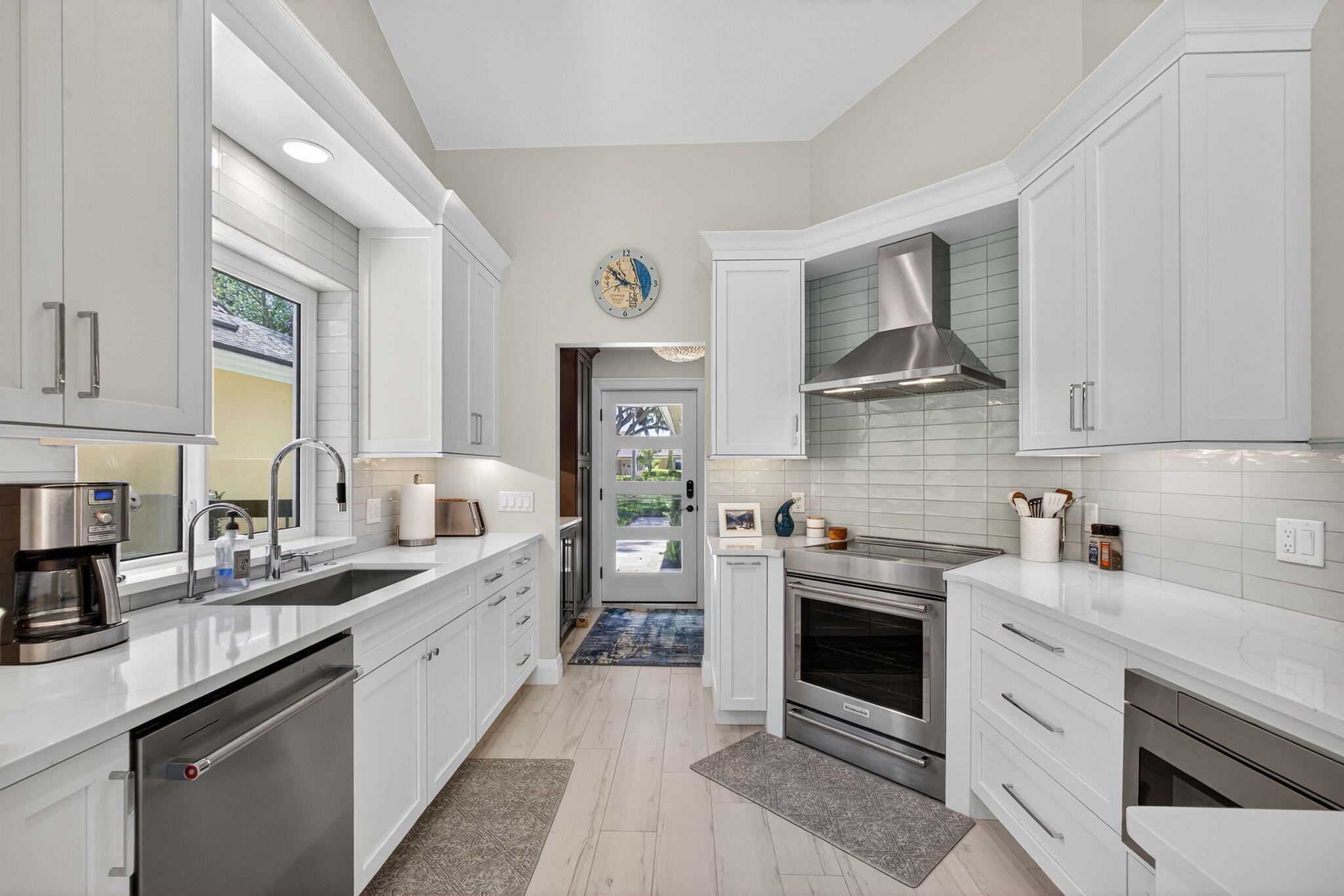156 Ocean Pines Terrace Jupiter, FL 33477 - Photo 10 of 41 a kitchen with a sink stove and cabinets