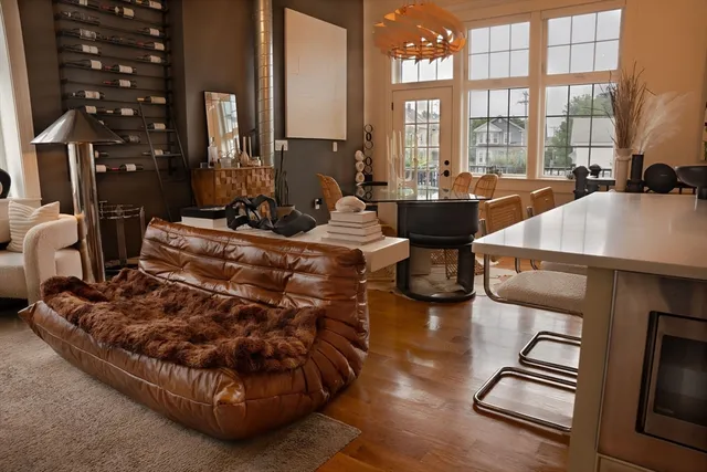 a living room with furniture and a floor to ceiling window