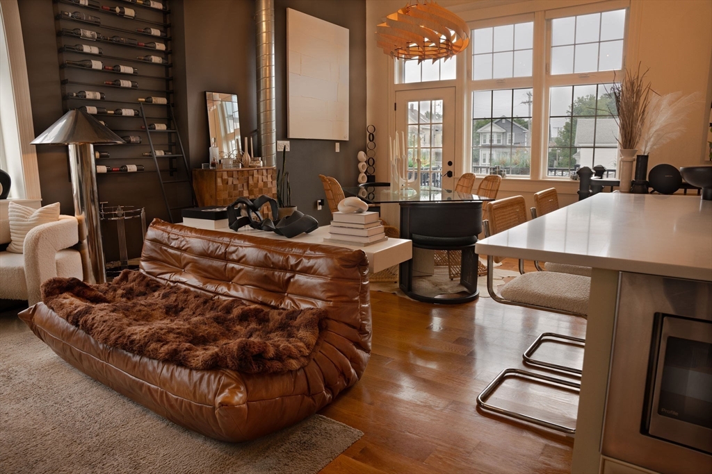 a living room with furniture and a floor to ceiling window