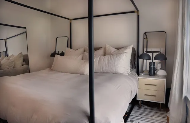 a bedroom with a bed and a dresser