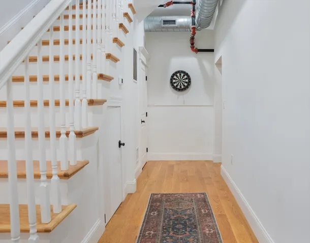a bedroom with a bed and flat tv screen on the dresser