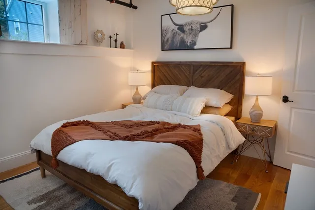 a living room with furniture a flat screen tv and a chandelier