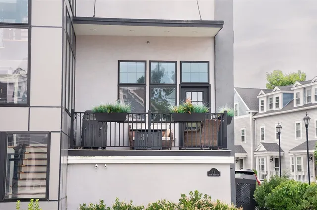 a living room with patio furniture and a chandelier
