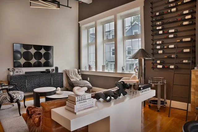 a living room with furniture and floor to ceiling windows