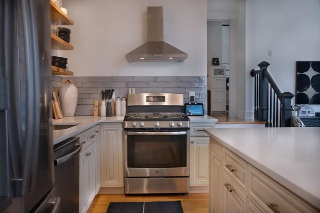 a kitchen with cabinets and stainless steel appliances