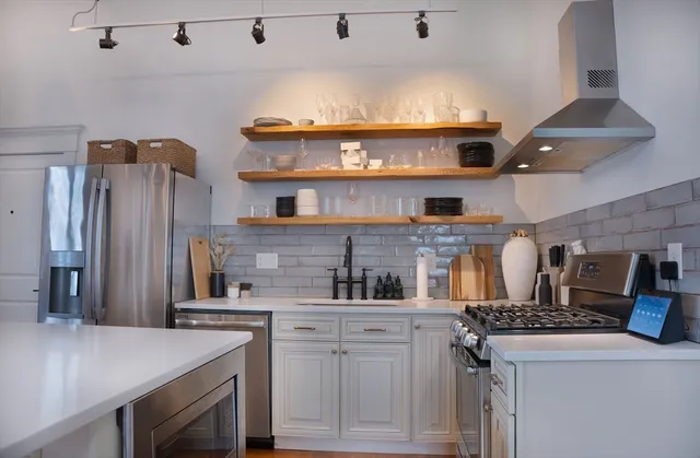 a kitchen with a stove and a refrigerator