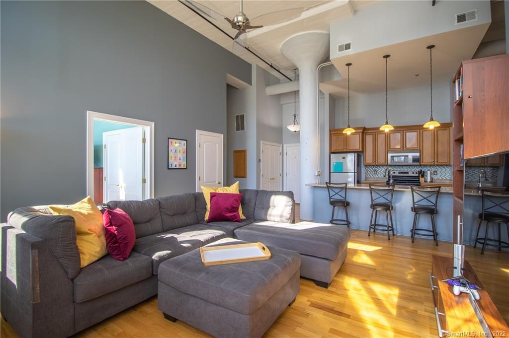 33 Mechanic Street, Unit 313 Windsor, CT 06095 - Photo 1 of 1 a living room with furniture and a chandelier