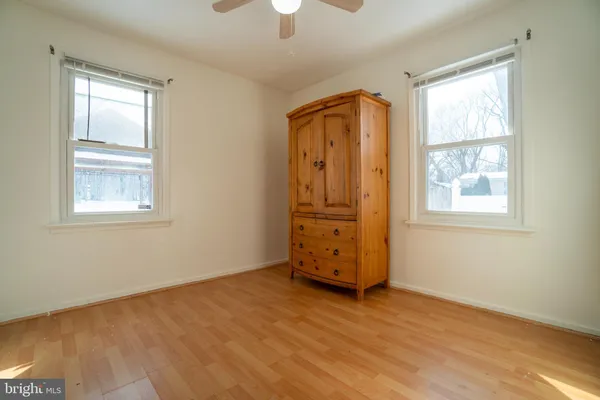 an empty room with windows and closet