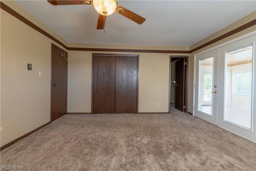 3963 Mark Road Cambridge, OH 43725 - Photo 26 of 50 Unfurnished bedroom featuring ceiling fan, french doors, carpet flooring, and access to outside