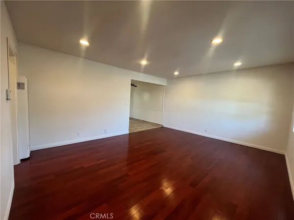 an empty room with wooden floor