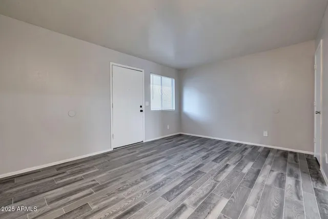 a view of an empty room and wooden floor