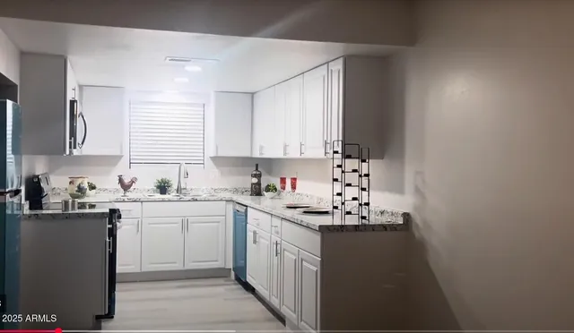 a kitchen with sink a stove and cabinets
