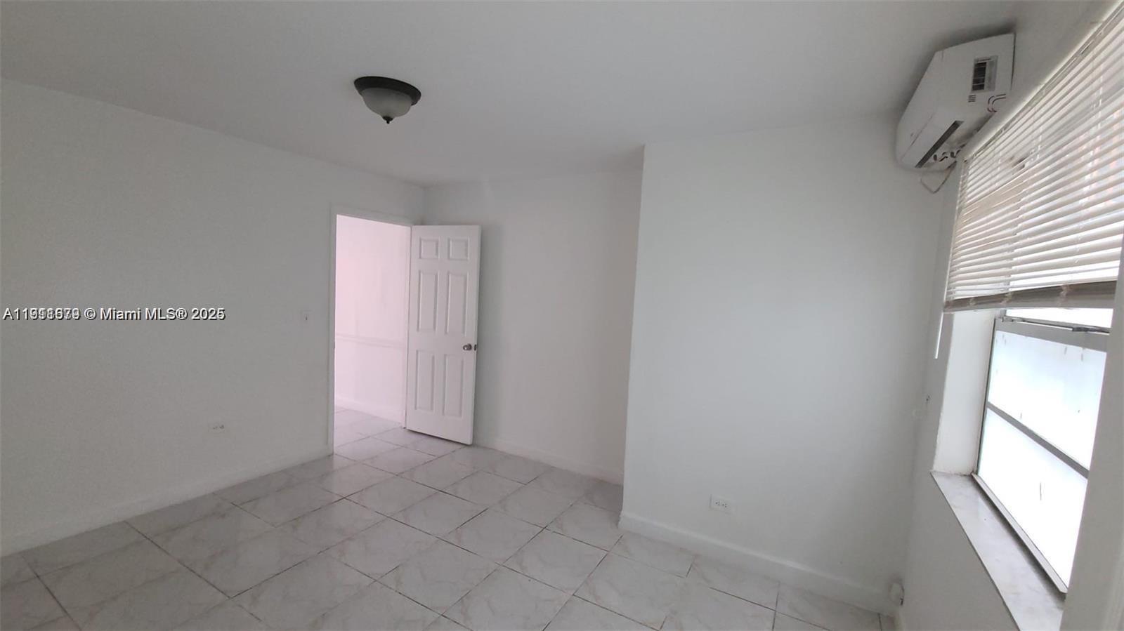 2015 Northwest 6th Place, Unit 5 Miami, FL 33127 - Photo 4 of 8 a view of an empty room with a window
