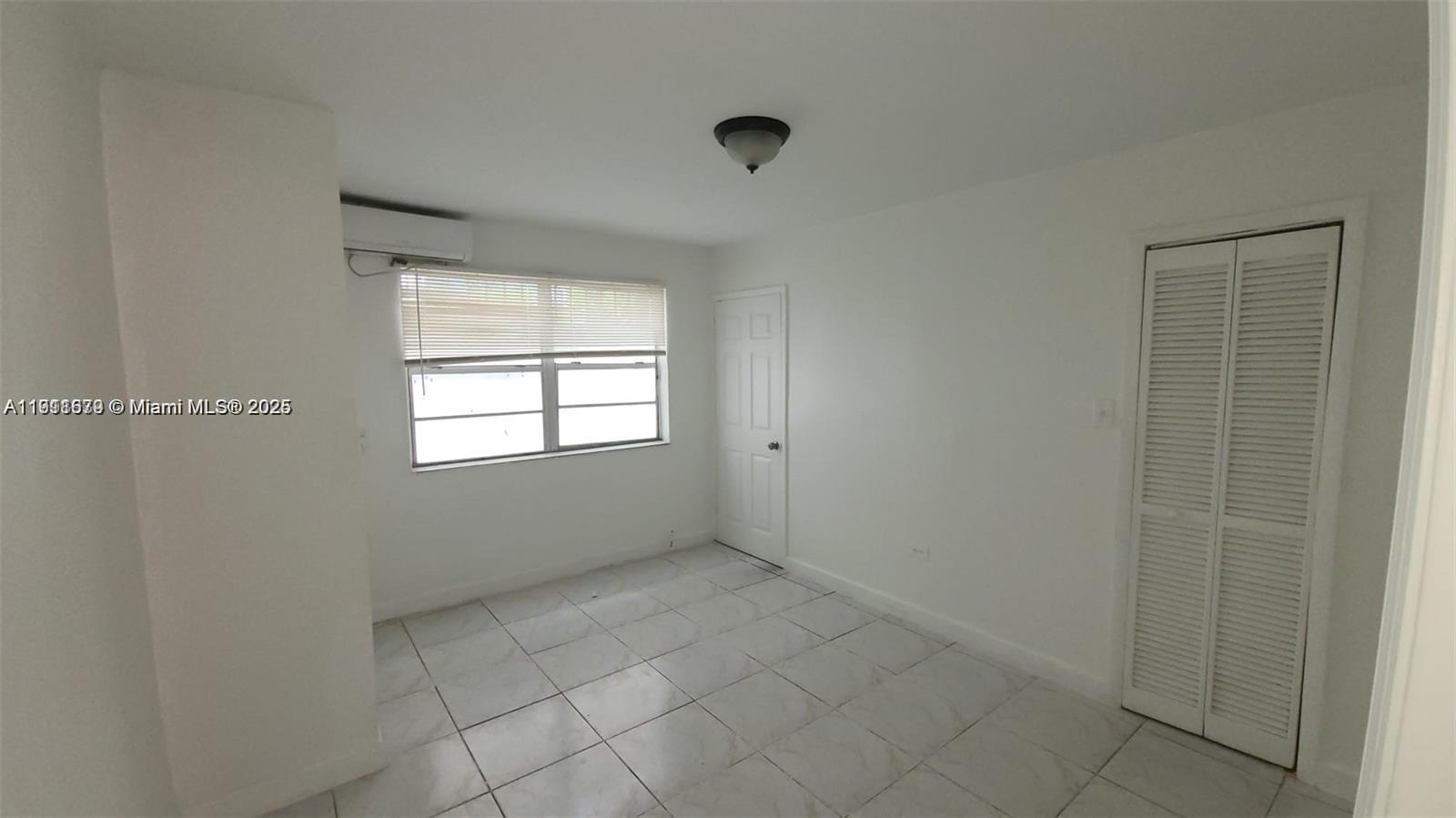 2015 Northwest 6th Place, Unit 5 Miami, FL 33127 - Photo 5 of 8 an empty room with windows