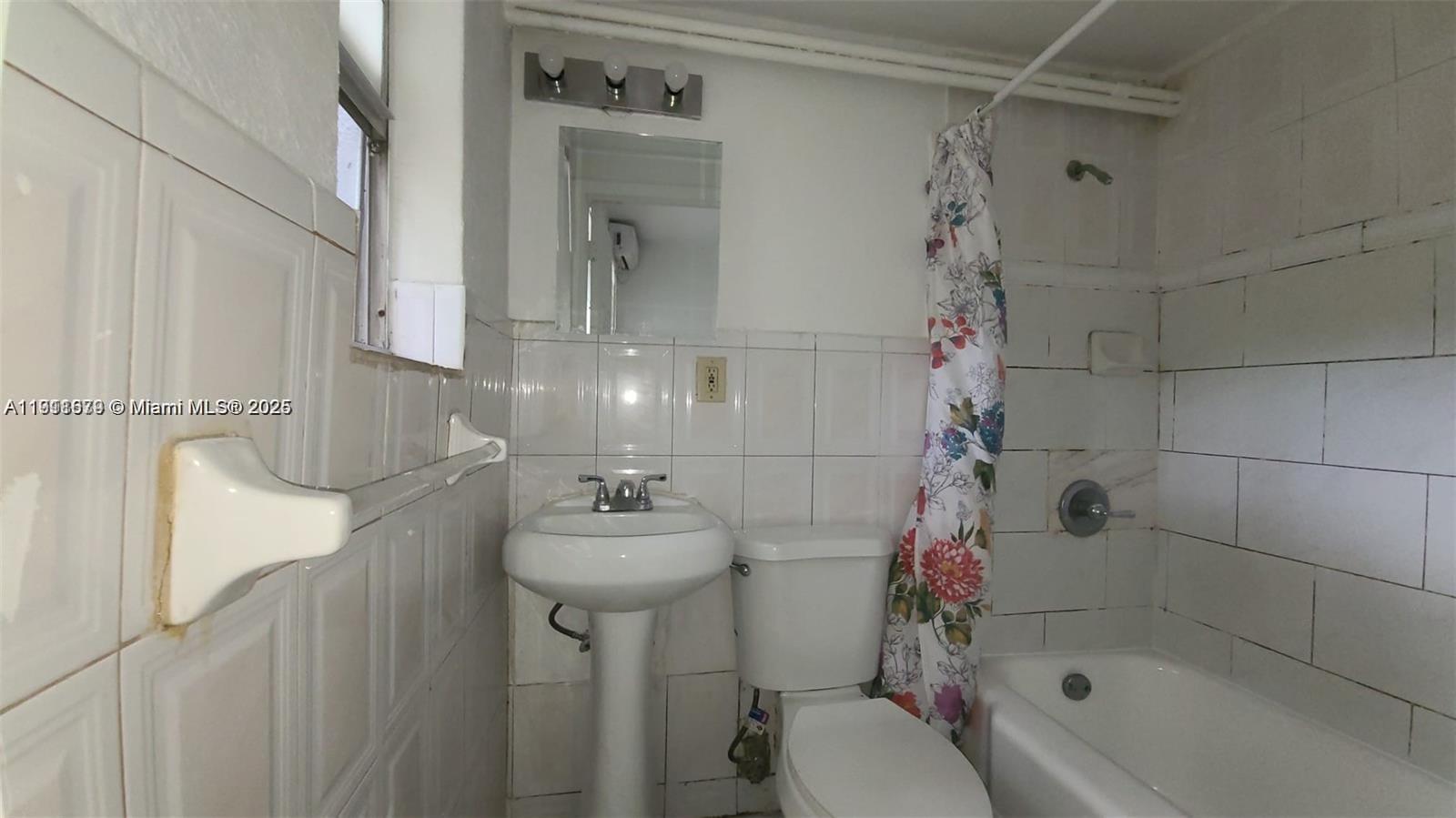 2015 Northwest 6th Place, Unit 5 Miami, FL 33127 - Photo 7 of 8 a bathroom with a sink toilet and shower