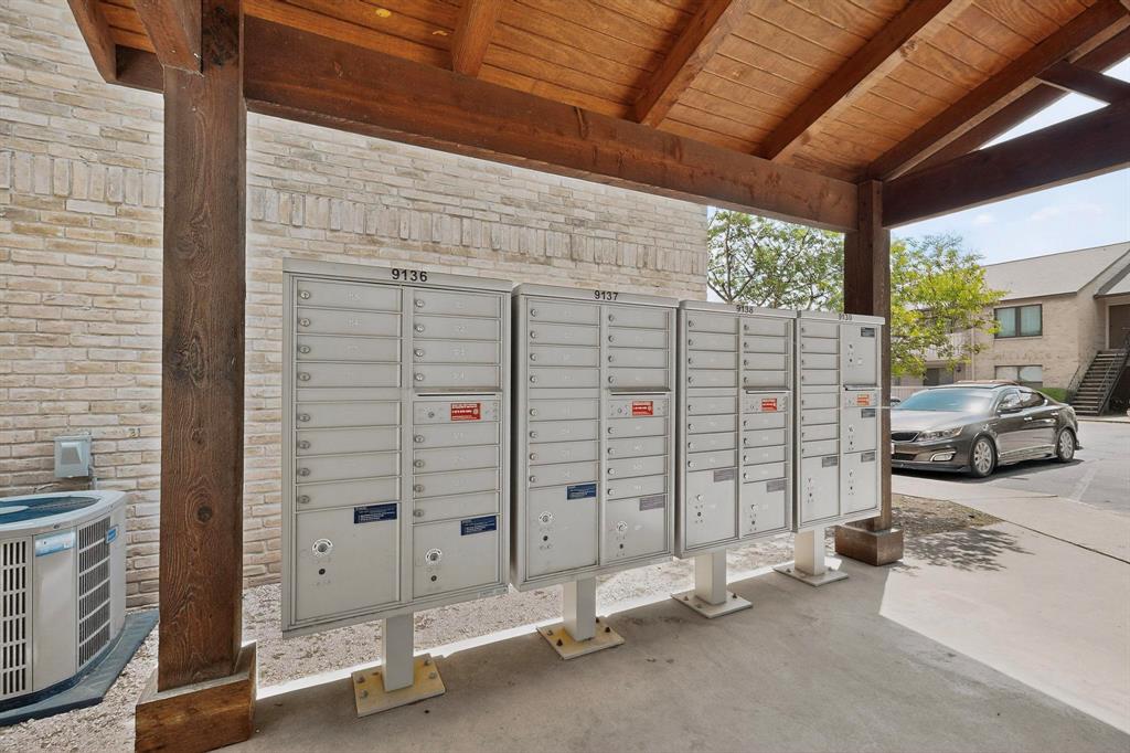 8210 Bent Tree Road, Unit 116 Austin, TX 78759 - Photo 16 of 21 Sturdy timber framing shelters the community mail station alongside brick exteriors and paved walkways.