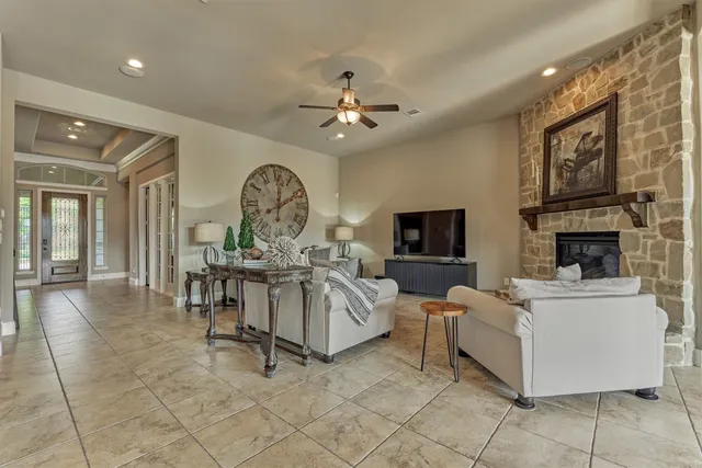 a large kitchen with stainless steel appliances granite countertop a stove top oven a sink dishwasher and a wooden cabinets