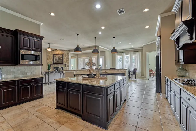 a bathroom with a granite countertop sink two mirror and a shower