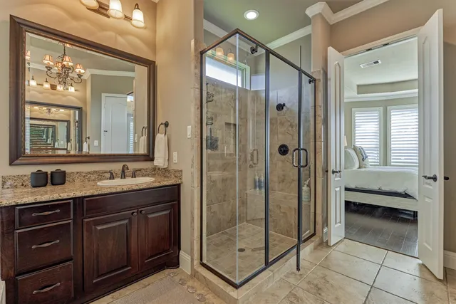 a bathroom with a granite countertop sink toilet mirror and shower