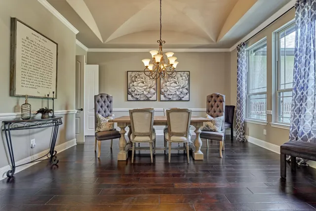 a kitchen with kitchen island granite countertop a refrigerator and wooden cabinets