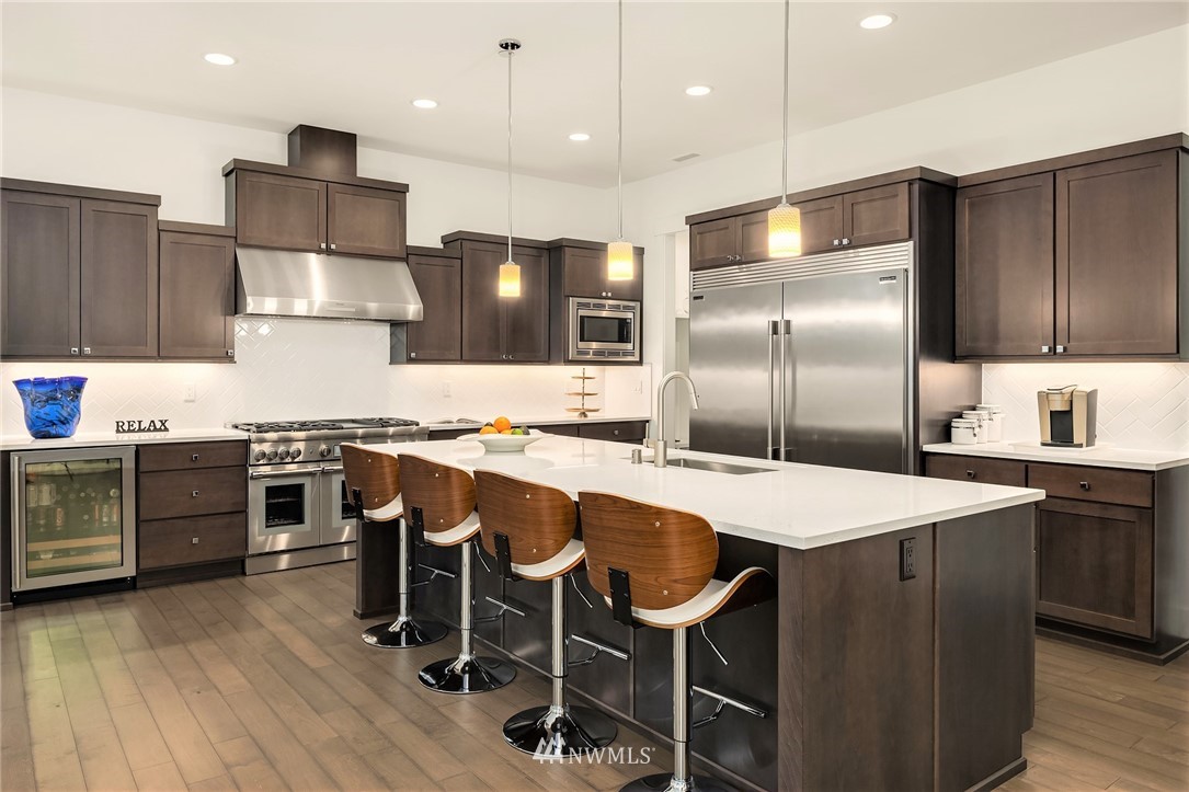 36234 Southeast Fish Hatchery Road Fall City, WA 98024 - Photo 8 of 33 a kitchen with kitchen island granite countertop a sink a stove a refrigerator and wooden floor
