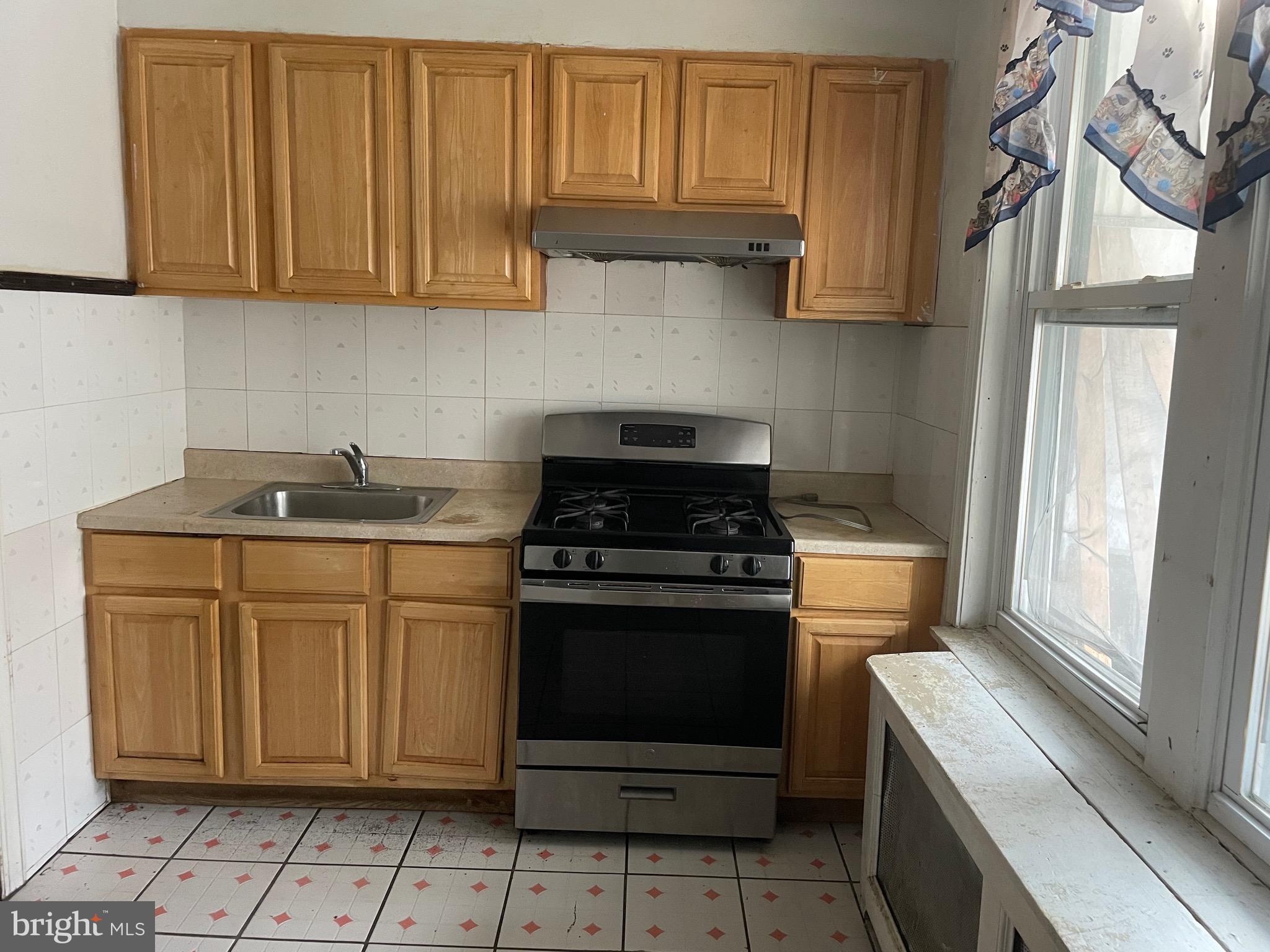 a kitchen with stainless steel appliances granite countertop a stove a refrigerator and a sink