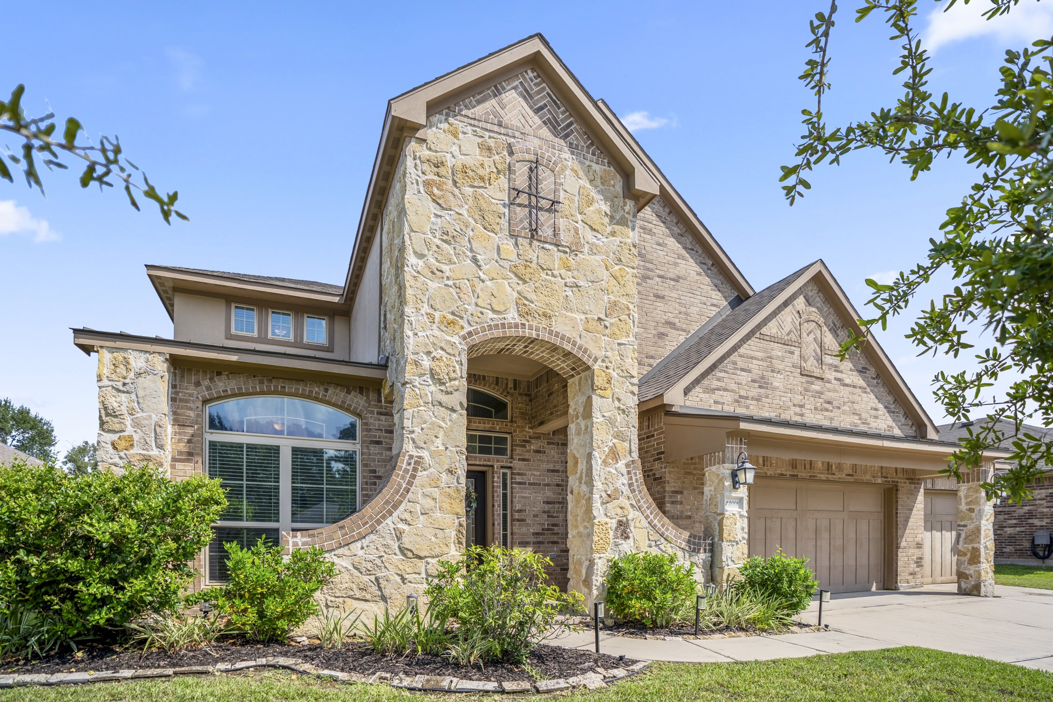 Beautifully set in McKenzie Park, this stone and brick façade creates lasting curb appeal and a warm welcome home.