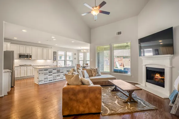 a living room with fireplace furniture and a flat screen tv