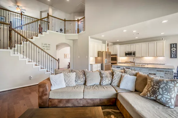 a living room with furniture and kitchen view