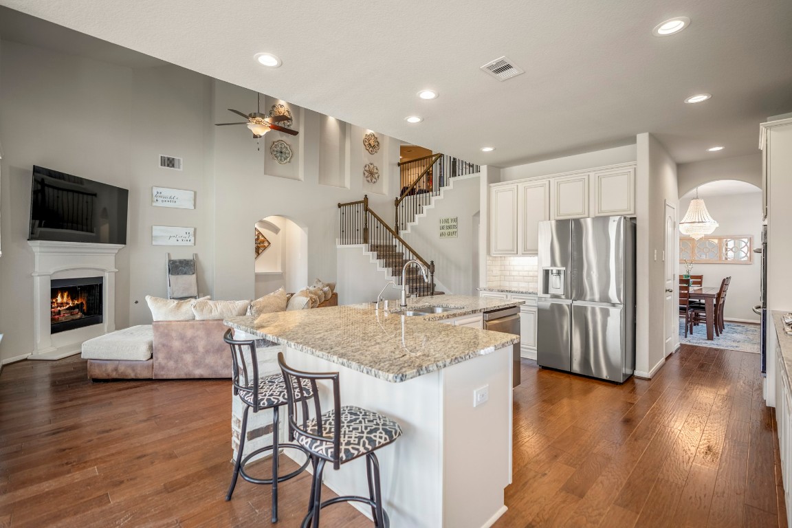 23006 Mulberry Tree Lane Spring, TX 77389 - Photo 15 of 50 From the island, views extend to the fireplace and two-story living room, blending cooking, dining, and gathering into one open space
