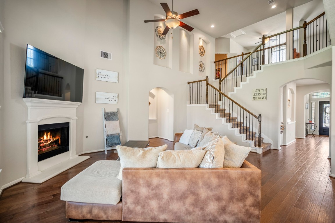 23006 Mulberry Tree Lane Spring, TX 77389 - Photo 20 of 50 An open two-story living room with fireplace connects seamlessly to the upstairs landing, creating a bright central gathering space.”