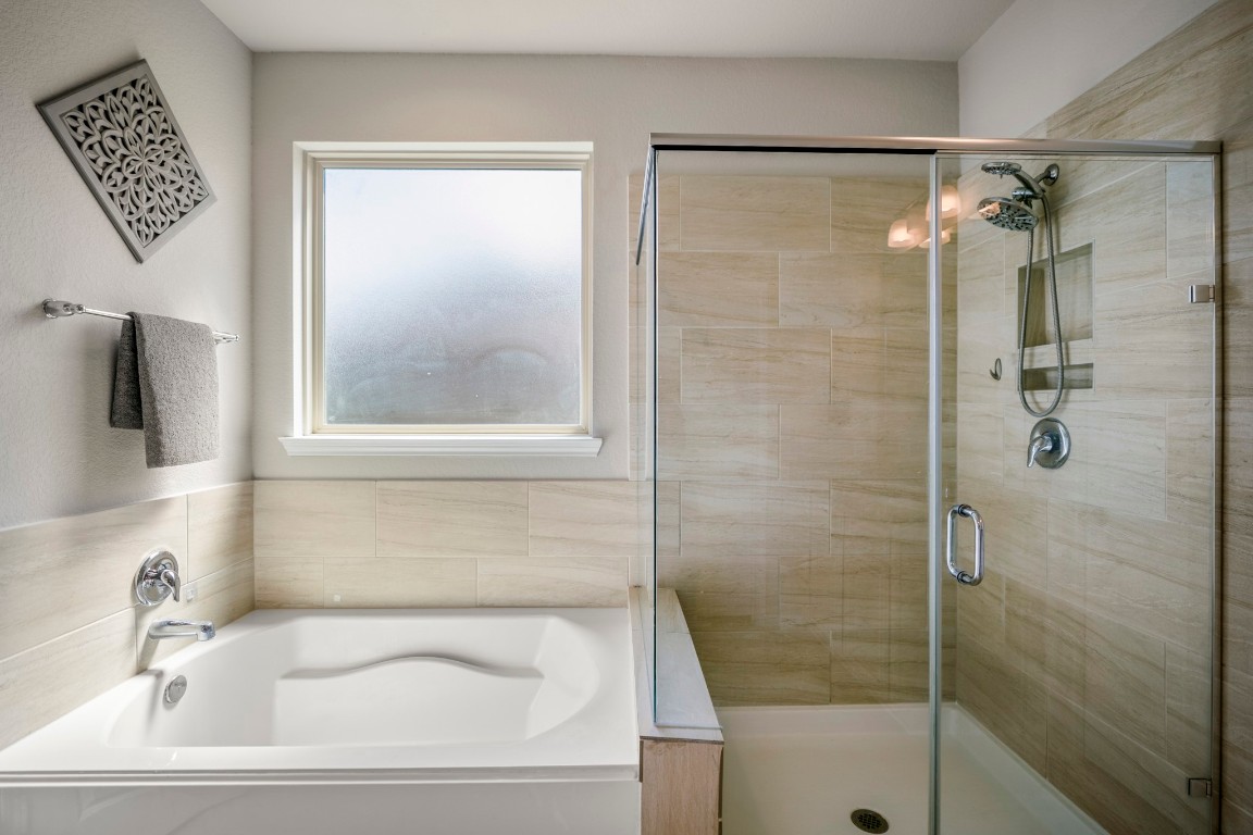 23006 Mulberry Tree Lane Spring, TX 77389 - Photo 24 of 50 A relaxing soaking tub pairs with a walk-in shower finished in neutral tile for a spa-like retreat.