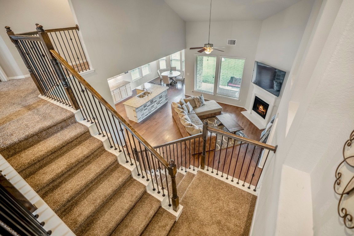 23006 Mulberry Tree Lane Spring, TX 77389 - Photo 27 of 50 From the upstairs landing, take in the open view of the living room, kitchen, and fireplace below—showcasing the home’s airy design.