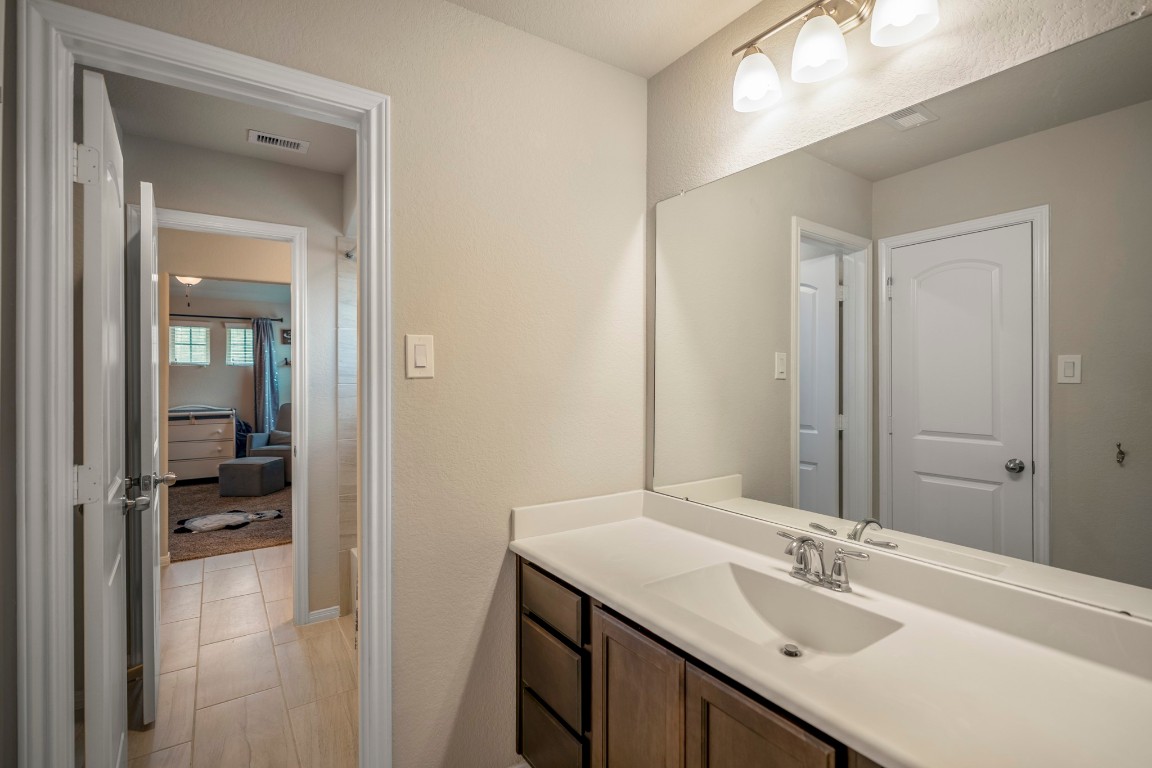 23006 Mulberry Tree Lane Spring, TX 77389 - Photo 35 of 50 Upstairs Jack-and-Jill bath connects two bedrooms, featuring an extended vanity and neutral finishes designed for everyday function and style.