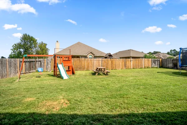 a view of a house with a yard and sitting area