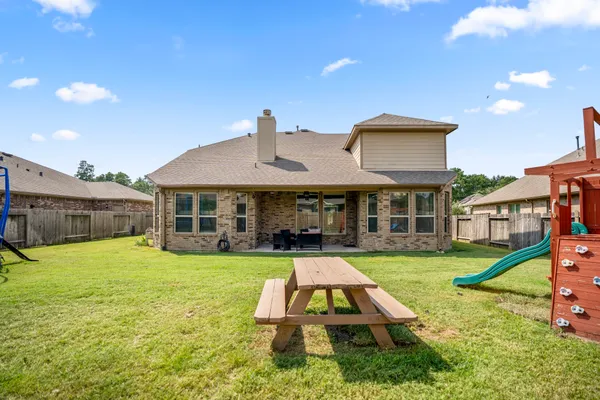 a front view of a house with a yard table and chairs