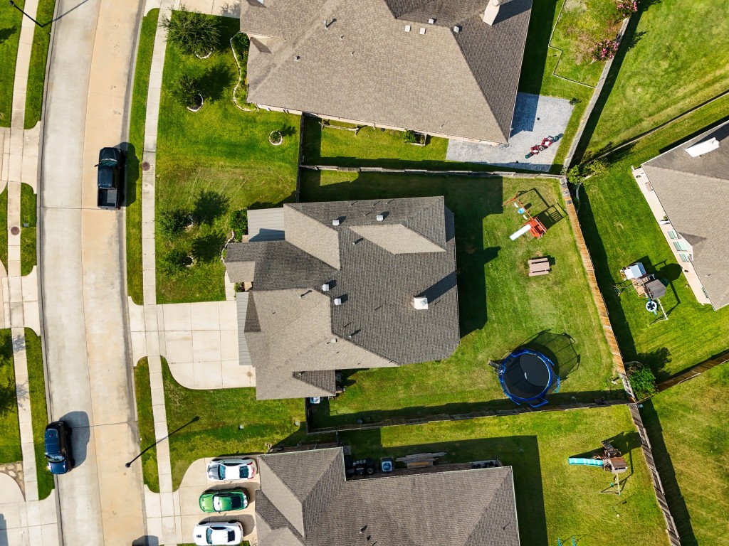 23006 Mulberry Tree Lane Spring, TX 77389 - Photo 44 of 50 Aerial perspective showcasing the full lot—ample backyard space, privacy fencing, and room to play, garden, or gather.