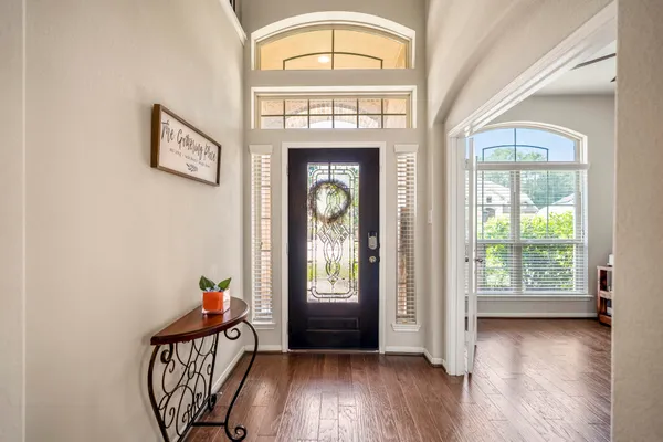 a view of an entryway with wooden floor