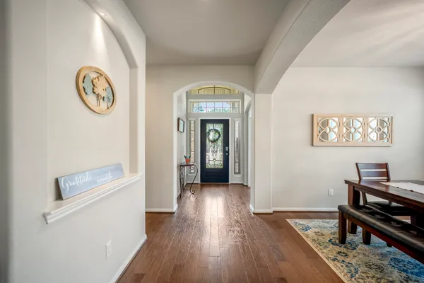 a view of a hallway with wooden floor
