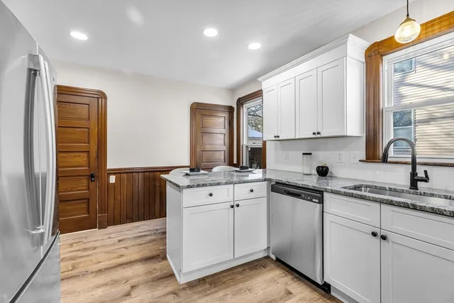 a kitchen with stainless steel appliances granite countertop a sink stove and refrigerator